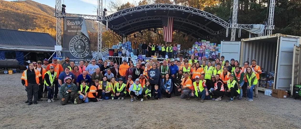 Dozens of Valley Strong volunteers in safety vests gathered for a group photo
